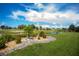 Picturesque backyard with a serene canal view, complemented by decorative rock gardens and lush plants at 1 Sportsman Cir, Rotonda West, FL 33947