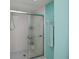 Clean bathroom featuring a white tiled shower and blue accent wall at 1 Sportsman Cir, Rotonda West, FL 33947