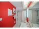 Bathroom showcasing the red walls and the vanity with ample lighting at 1 Sportsman Cir, Rotonda West, FL 33947