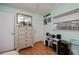 Bright bedroom featuring hardwood floors, light green walls, and natural light from the window at 1 Sportsman Cir, Rotonda West, FL 33947