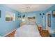 Cozy bedroom featuring cool blue walls and natural light from the window at 1 Sportsman Cir, Rotonda West, FL 33947