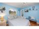 Relaxing bedroom with blue walls, a ceiling fan, and outdoor views at 1 Sportsman Cir, Rotonda West, FL 33947