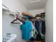 Brightly lit walk in closet with metal shelving and a variety of clothing at 1 Sportsman Cir, Rotonda West, FL 33947