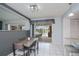 Bright dining area with white tile floors offers a view of the outdoor pool area and patio at 1 Sportsman Cir, Rotonda West, FL 33947