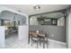 Dining area with white tile, gray accent wall, and seating for four is adjacent to the living area at 1 Sportsman Cir, Rotonda West, FL 33947