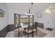 Dining room with a large bay window, contemporary chandelier, and modern table set at 1 Sportsman Cir, Rotonda West, FL 33947