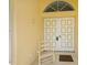 Charming front porch with a cozy rocking chair and a decorative front door at 1 Sportsman Cir, Rotonda West, FL 33947