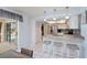 Open kitchen with stainless appliances, granite counters, and bar seating is adjacent to the outdoor pool at 1 Sportsman Cir, Rotonda West, FL 33947