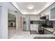 Modern kitchen with stainless appliances, granite counters, and an open view into the living area at 1 Sportsman Cir, Rotonda West, FL 33947