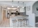 Kitchen with stainless appliances, granite counters and bar seating beneath pendant lights at 1 Sportsman Cir, Rotonda West, FL 33947