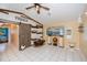 Bright living room featuring a sliding barn door, mounted TV, and tile flooring at 1 Sportsman Cir, Rotonda West, FL 33947