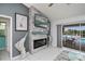 Living room featuring a fireplace with tile surround, and a sliding glass door to the pool at 1 Sportsman Cir, Rotonda West, FL 33947