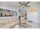 Open-concept living space with a ceiling fan and view into the dining and kitchen areas at 1 Sportsman Cir, Rotonda West, FL 33947