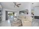 Living room featuring sliding glass doors to lanai and pool area, neutral color scheme at 1 Sportsman Cir, Rotonda West, FL 33947