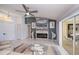 Living room featuring a ceiling fan, fireplace, view to backyard, and an open floor plan at 1 Sportsman Cir, Rotonda West, FL 33947
