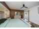 This primary bedroom includes a slider to the pool, dressers and light wood flooring at 1 Sportsman Cir, Rotonda West, FL 33947