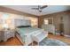 This primary bedroom includes wood floors, neutral paint, bench and seahorse art at 1 Sportsman Cir, Rotonda West, FL 33947