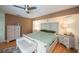 This is the primary bedroom, including a ceiling fan, a bed, dressers and a bench at 1 Sportsman Cir, Rotonda West, FL 33947