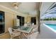 Outdoor patio featuring comfortable seating with views of the inviting screened-in pool area at 1 Sportsman Cir, Rotonda West, FL 33947