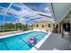 Inviting screened-in pool area with a vibrant pool, spacious deck, and sunny atmosphere at 1 Sportsman Cir, Rotonda West, FL 33947