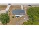 An aerial view showcases the property, neighborhood, and surrounding landscape at 10133 Gulfstream Blvd, Englewood, FL 34224