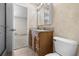 Cozy bathroom features wood vanity, granite countertop, tile flooring, and walk-in shower at 10133 Gulfstream Blvd, Englewood, FL 34224