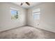 Comfortable bedroom with carpet, two bright windows, and ceiling fan, creating a peaceful and airy atmosphere at 10133 Gulfstream Blvd, Englewood, FL 34224