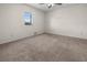 Bedroom with plush carpet flooring and ample natural light from window at 10133 Gulfstream Blvd, Englewood, FL 34224