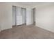 Bedroom features an open closet with built-in drawers and carpeted floor at 10133 Gulfstream Blvd, Englewood, FL 34224