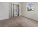 Carpeted bedroom with a built-in closet and a window, offering both storage and a view of the outdoors at 10133 Gulfstream Blvd, Englewood, FL 34224