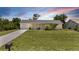 Charming single-story home with a well-maintained lawn and a cozy, inviting facade at 10133 Gulfstream Blvd, Englewood, FL 34224