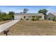 Charming single-story home with a well-maintained lawn and a cozy, inviting facade at 10133 Gulfstream Blvd, Englewood, FL 34224