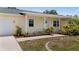 Charming home with a welcoming front porch, decorative landscaping, and a pleasant curb appeal at 10133 Gulfstream Blvd, Englewood, FL 34224
