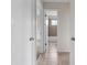 Hallway featuring bathroom and carpeted rooms with multiple doors, providing privacy and access to different areas at 10133 Gulfstream Blvd, Englewood, FL 34224