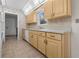 Functional kitchen with wooden cabinets, white countertops, and tiled backsplash, offering ample storage and workspace at 10133 Gulfstream Blvd, Englewood, FL 34224