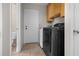 Laundry room features a washer, dryer and access door at 10133 Gulfstream Blvd, Englewood, FL 34224