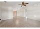 Spacious living room with neutral tile flooring, ceiling fan, and ample natural light at 10133 Gulfstream Blvd, Englewood, FL 34224