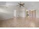 Bright living room with tile flooring, ceiling fan, and open view to kitchen at 10133 Gulfstream Blvd, Englewood, FL 34224
