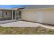 View of the concrete patio outside the home and screened in patio at 10133 Gulfstream Blvd, Englewood, FL 34224
