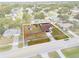 Overhead view of a cozy home on a fenced lot surrounded by lush landscaping at 1041 S Salford Blvd, North Port, FL 34287