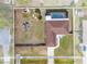 Aerial view displays pool, expansive backyard with fencing, and patio of property at 1041 S Salford Blvd, North Port, FL 34287