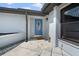 Welcoming entryway with stylish blue front door and manicured landscaping at 1041 S Salford Blvd, North Port, FL 34287
