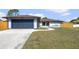 Beautiful one story home with a blue garage door and manicured lawn at 1041 S Salford Blvd, North Port, FL 34287