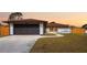 Charming single-story home featuring a wide driveway and well-maintained lawn at 1041 S Salford Blvd, North Port, FL 34287