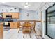 Cozy eat-in kitchen area with wood table set and sliding glass door to the backyard at 1041 S Salford Blvd, North Port, FL 34287