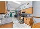 Well-lit kitchen with stainless steel appliances, tile flooring, and a view into dining area at 1041 S Salford Blvd, North Port, FL 34287