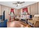 Comfortable living room with stylish striped wallpaper, ceiling fan, and well-coordinated furniture at 1041 S Salford Blvd, North Port, FL 34287