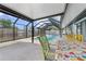 Enjoy outdoor dining by the pool under the covered patio area, perfect for entertaining at 1041 S Salford Blvd, North Port, FL 34287