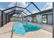 Relaxing screened-in pool area with lounge chairs and plenty of natural light at 1041 S Salford Blvd, North Port, FL 34287