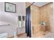 Tiled bathroom shower with built in seat, decorative accessories, and updated fixtures at 1041 S Salford Blvd, North Port, FL 34287
